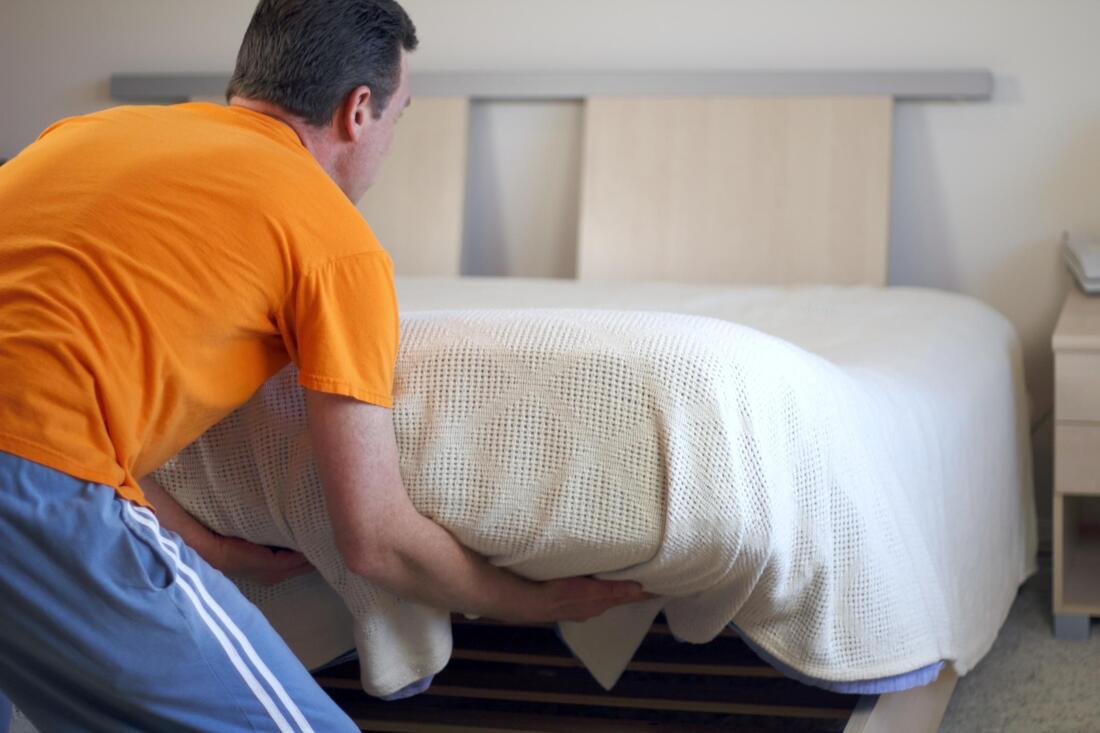 man preparing the bed